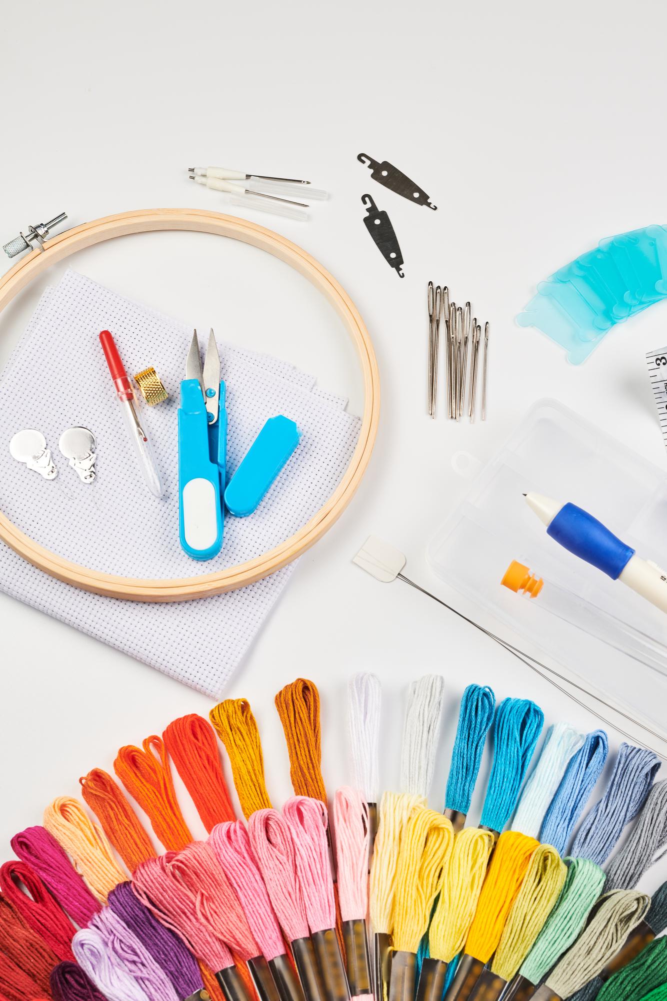 Stack of embroidery kits and tools